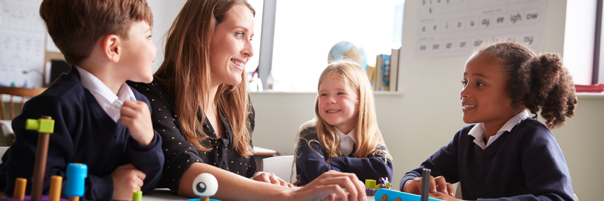Teacher with young students in classroom