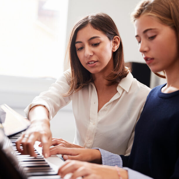 Female Teacher with pupil on piano